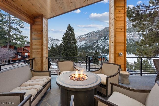 Balcony with a mountain view and an outdoor living space with a fire pit | Image 71