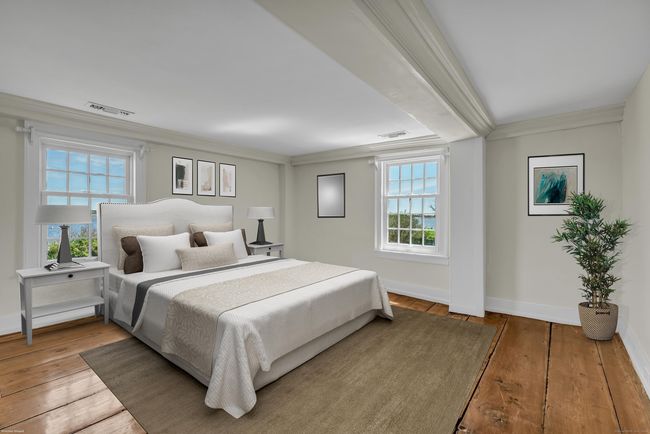 The Spacious Upper Level Primary Suite Offers Gracious Water Views Of North Cove | Image 26