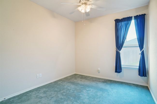 Carpeted bedroom featuring baseboards and a ceiling fan | Image 21