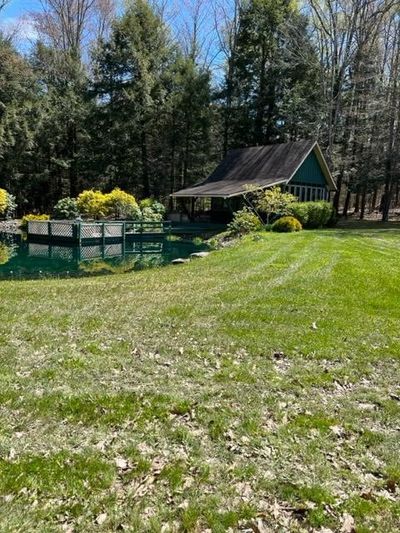 Beautiful lake with cottage overlooking it. | Image 2