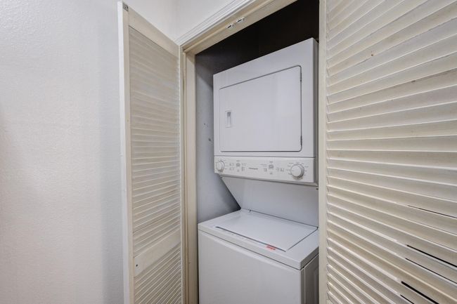 Laundry room with stacked washer and clothes dryer | Image 8