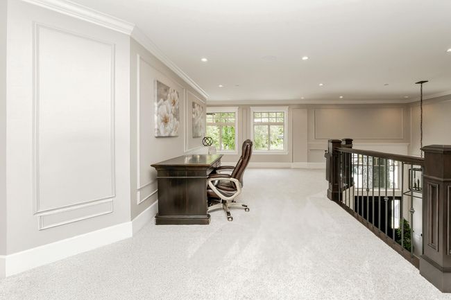 Office space with crown molding, carpet floors, and a decorative wall | Image 28