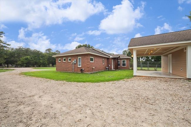 ON THE RIGHT SIDE OF THE HOME, A FIRMLY PACKED DRIVEWAY OFFERS EASY ACCESS AND LEADS TO A SPACIOUS SECONDARY BUILDING- PERFECT FOR WORKSHOP, STORAGE AND GAME ROOM. IT OFFERS A CHARMING PORCH PROVIDING ADDITIONAL SPACE TO RELAX | Image 44