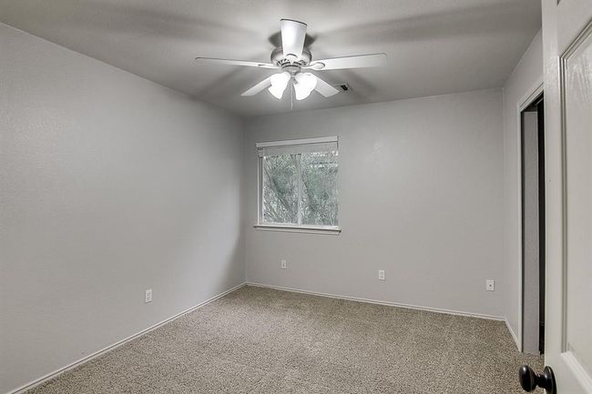 Unfurnished bedroom with carpet flooring and a ceiling fan | Image 16