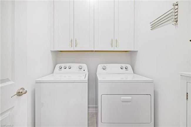Washroom with washer and clothes dryer and cabinet space | Image 23