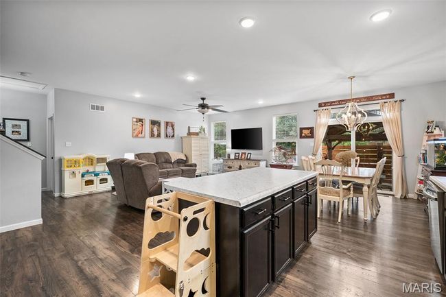 Kitchen featuring light countertops, a ceiling fan, recessed lighting, dark wood-style flooring, and a center island | Image 12