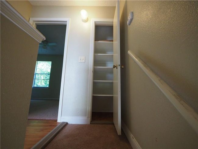Hallway with carpet floors and baseboards | Image 19