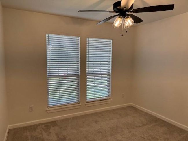 Empty room featuring a ceiling fan, carpet floors, and baseboards | Image 34