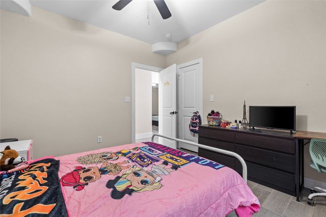 Bedroom with light wood-type flooring and a ceiling fan | Image 26