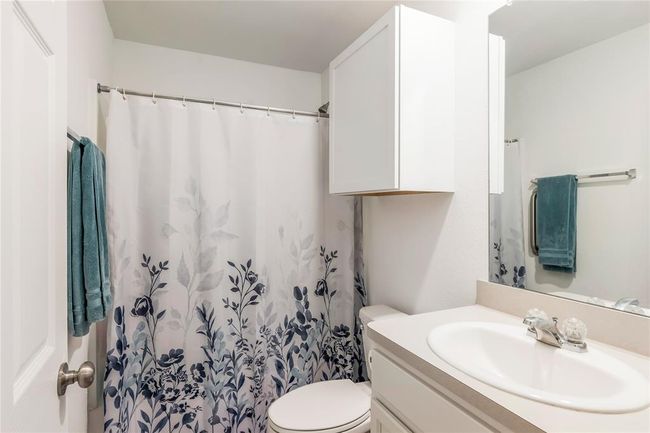 Stylish primary bathroom with a Tub/Shower Combo. | Image 15