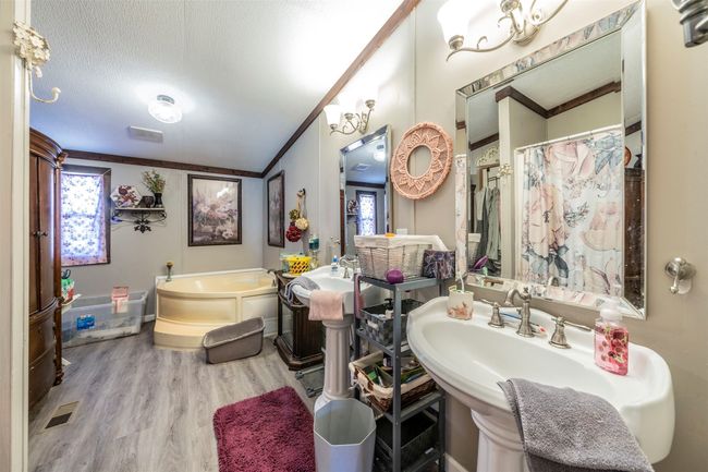Large primary bathroom with tub, shower stall and huge walk in closet. | Image 11