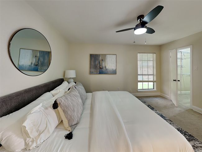 Carpeted bedroom with ceiling fan, baseboards, and ensuite bathroom | Image 6