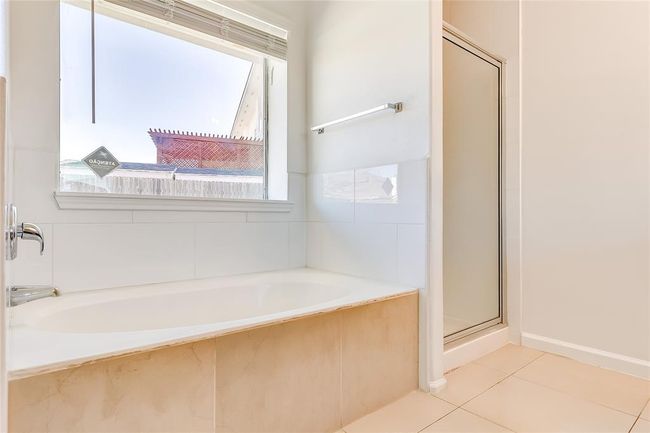 Full bath with a garden tub, tile patterned flooring, and a stall shower | Image 23