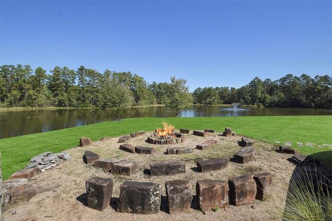 Cozy up next to the wood burning firepit with rock seating | Image 46
