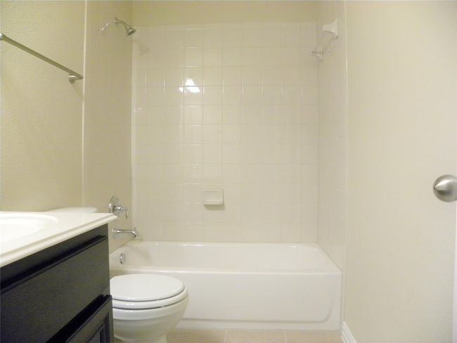 Bathroom featuring vanity, tile patterned flooring, and tub / shower combination | Image 25