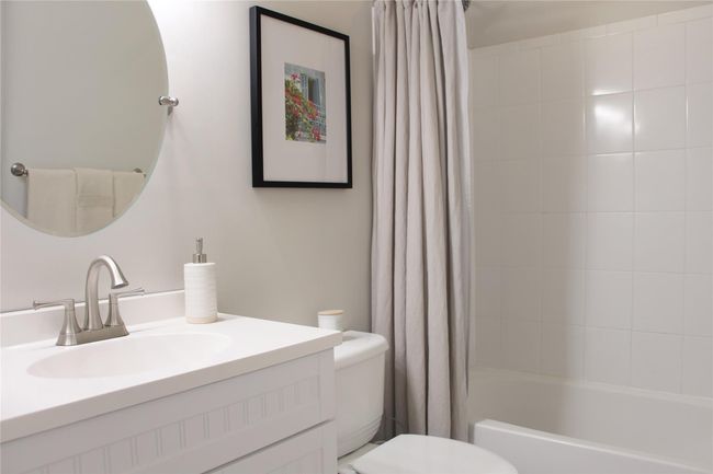 Full bathroom featuring toilet, vanity, and shower / tub combo with curtain | Image 15