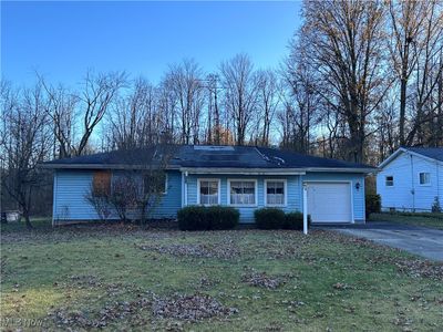 Single story home with a front lawn and a garage | Image 1