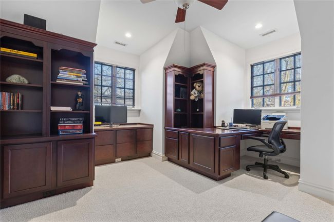 Office space with ceiling fan, plenty of natural light, and light carpet | Image 24