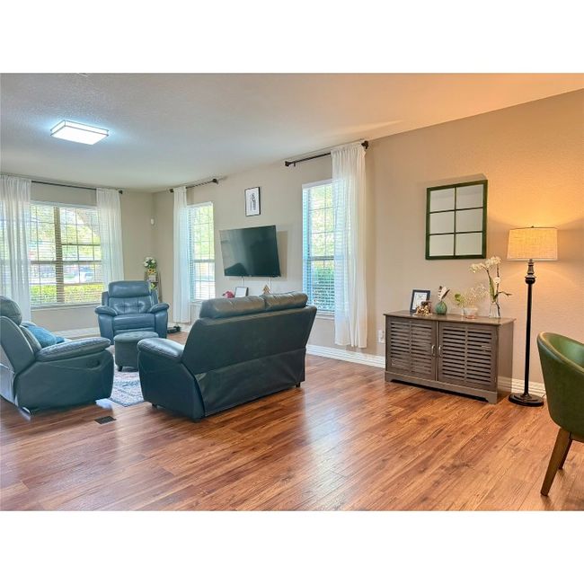 Spacious family room with plenty of windows which provide natural light | Image 12