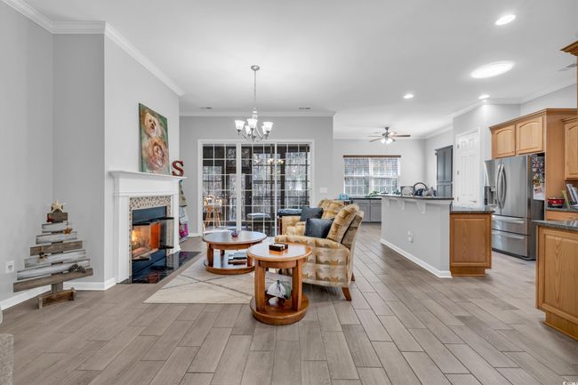 Living area featuring baseboards, light wood-style floors, and a fireplace | Image 20
