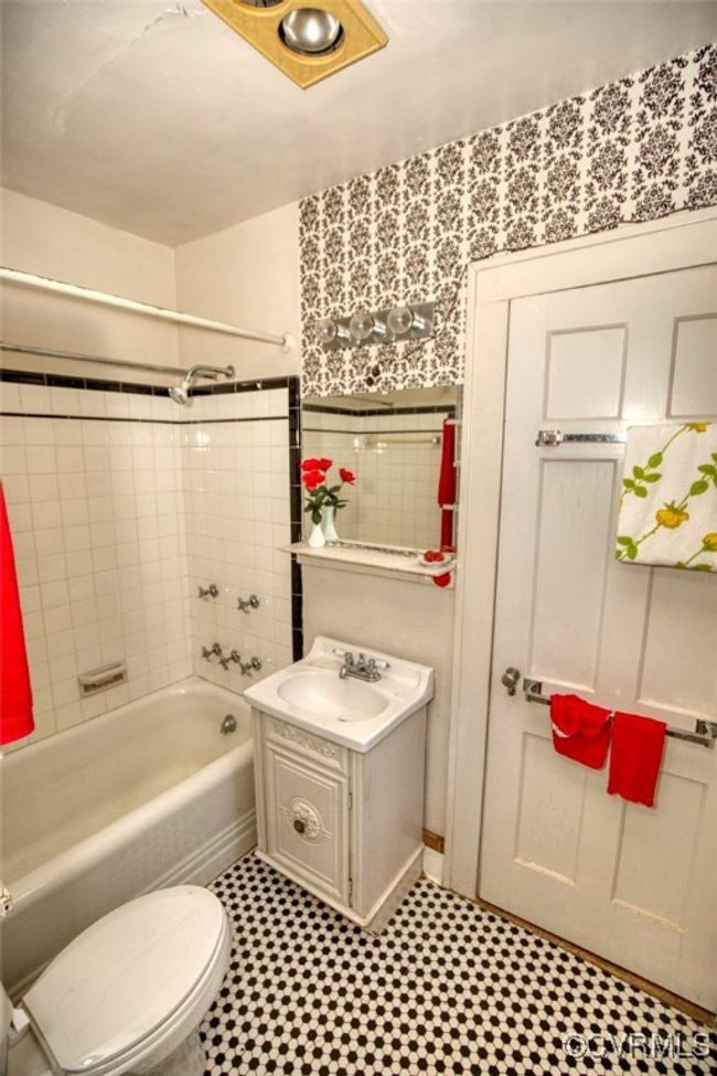 Bathroom with washtub / shower combination, vanity, wallpapered walls, tile patterned floors, and toilet | Image 21