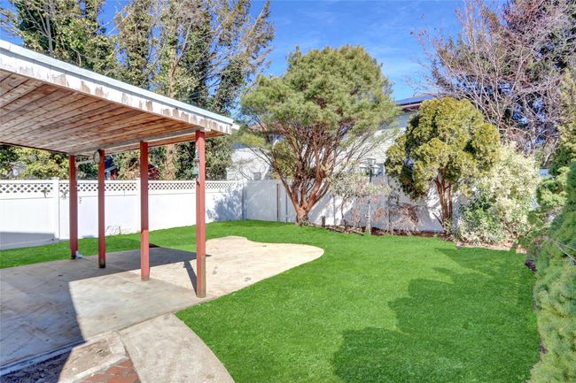 View of yard with a patio area and fence | Image 20