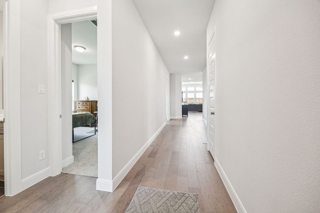 Hall featuring wood finished floors, recessed lighting, and baseboards | Image 6