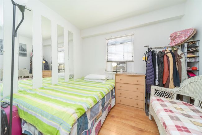 Bedroom featuring cooling unit and light wood finished floors | Image 11
