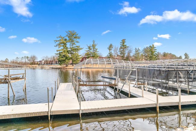 Unit includes the boat slip and lift with cover for a 25' pontoon. | Image 55