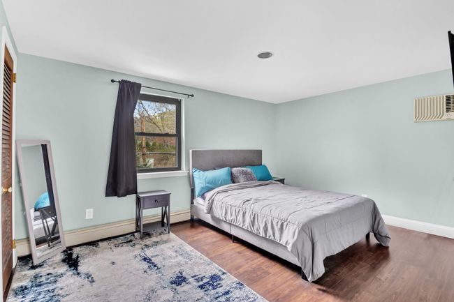 Bedroom featuring baseboards and wood finished floors | Image 17