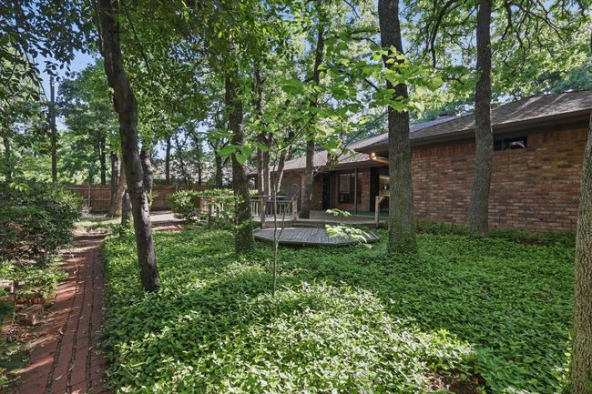 View of yard with a wooden deck and fence | Image 30