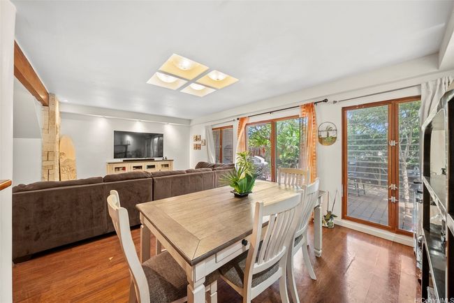 Dining area, looking towards the living room with plenty of windows for light and breeze. | Image 6