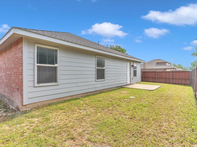 Rear view of property featuring brick siding and a patio area | Image 28