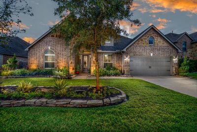 This could be your new home! Beautiful elevation with lush landscaping and uplighting on a cul-de-sac backing up to one of the neighborhood lakes, fountain, and walking trails! | Image 1