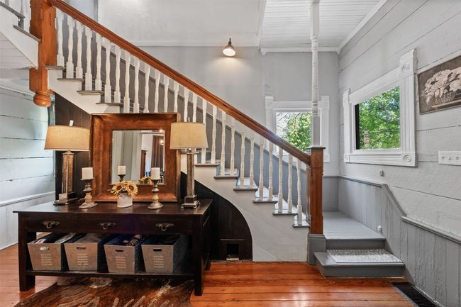 Stairs featuring hardwood / wood-style floors and wooden walls | Image 8