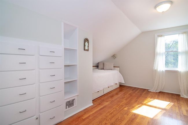 Unfurnished bedroom featuring light wood-style flooring, visible vents, vaulted ceiling, and baseboards | Image 15