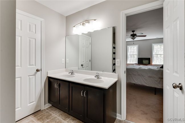 Full bath featuring ceiling fan, connected bathroom, and double vanity | Image 18