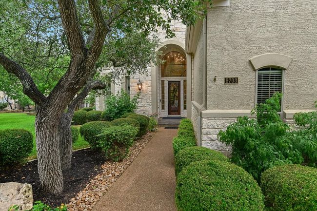 Gracious entrance featuring professionally landscaped yard. | Image 4