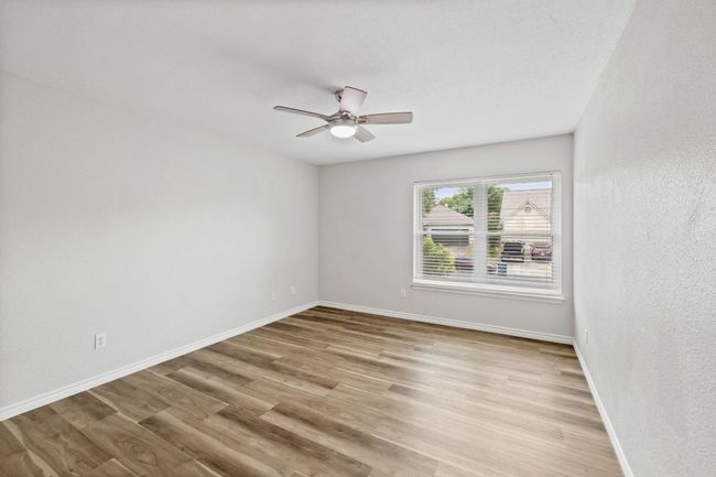 Unfurnished room featuring baseboards, wood finished floors, and a ceiling fan | Image 24
