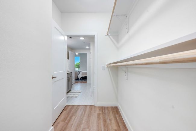 Spacious closet featuring light wood-style floors | Image 24