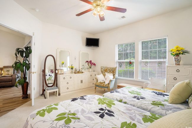 Bedroom featuring light colored carpet and ceiling fan | Image 20