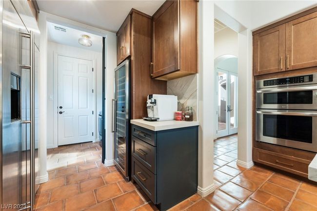 Newly added coffee bar and wine fridge, stainless steel oven and a new barn door into the laundry room. | Image 9