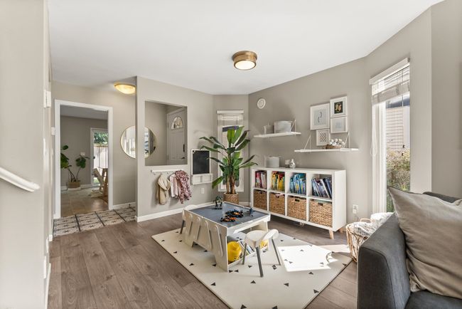Living area with plenty of natural light, wood finished floors, and baseboards | Image 13