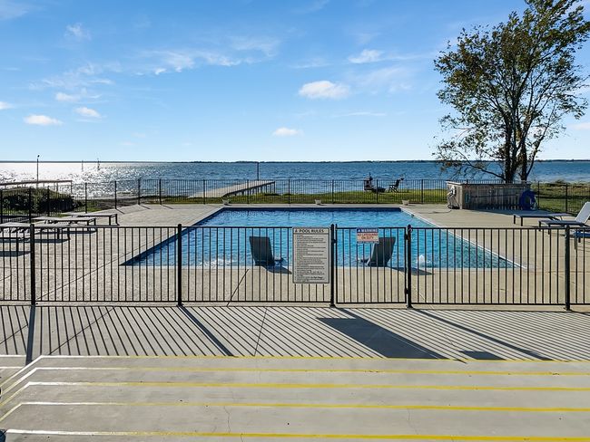 Community pool with a water view and a patio area | Image 11