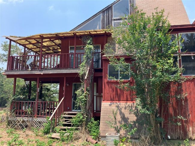 A-Frame House in need of repair or removal. Property is secluded with mature native trees. | Image 13