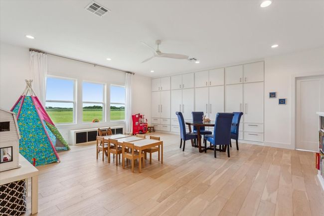 Dining area with light wood finished floors, recessed lighting, a ceiling fan, and radiator | Image 20