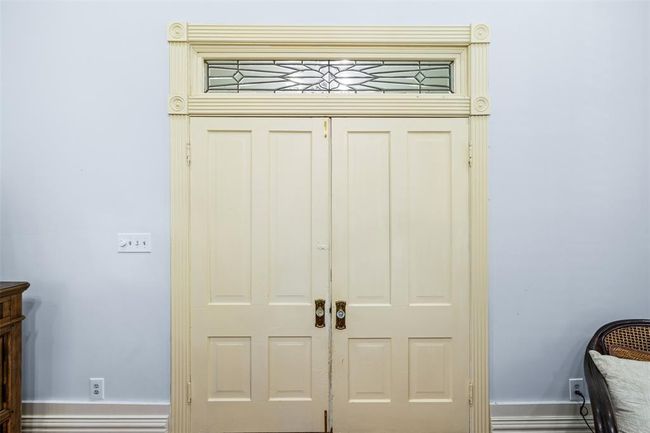 Step through elegant double doors adorned with decorative glass into your serene primary suite. | Image 15