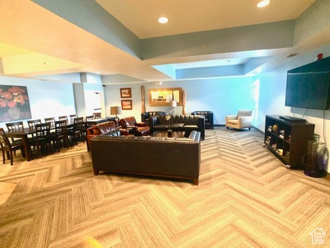 Carpeted living area with recessed lighting and a tray ceiling | Image 17