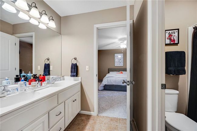 Jack and Jill bathroom, upper level with double vanity, tile flooring and a shower over tub. | Image 23