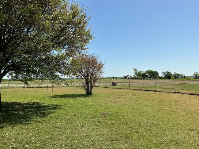 View of yard featuring a rural view and fence | Image 23